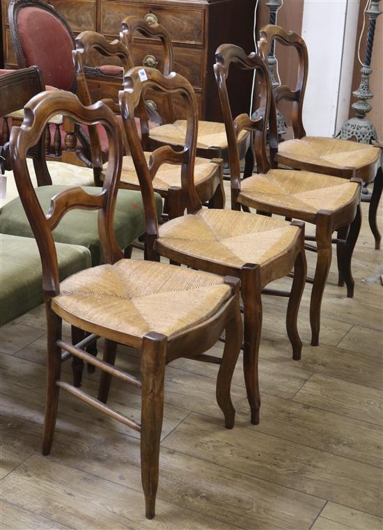 A set of six 19th century French stained beech rush seated dining chairs